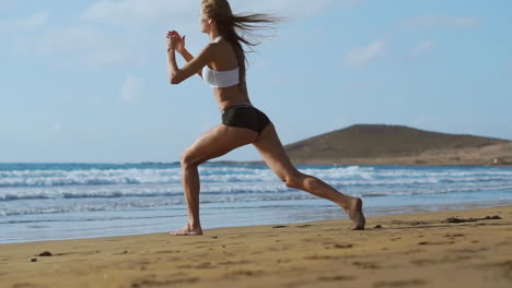 Sport-girl-on-a-beach-doing-lunges-exercises.-Concept-of-of-a-healthy-lifestyle